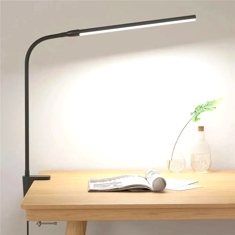 By Levin black single-head gooseneck LED desk lamp with clamp mount, providing bright task lighting on a wooden desk.
