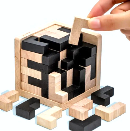 By Levin wooden 3D cube puzzle with black and natural wood geometric pieces being assembled in a wooden frame