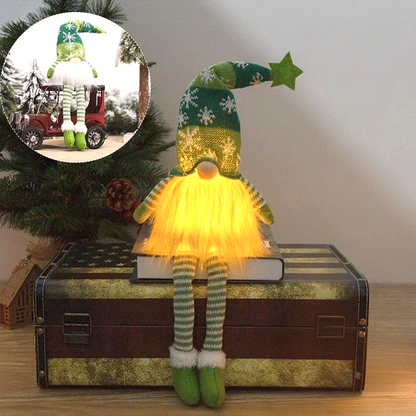 By Levin green plush Christmas gnome with LED light, snowflake hat, star topper, and dangling striped legs on a trunk