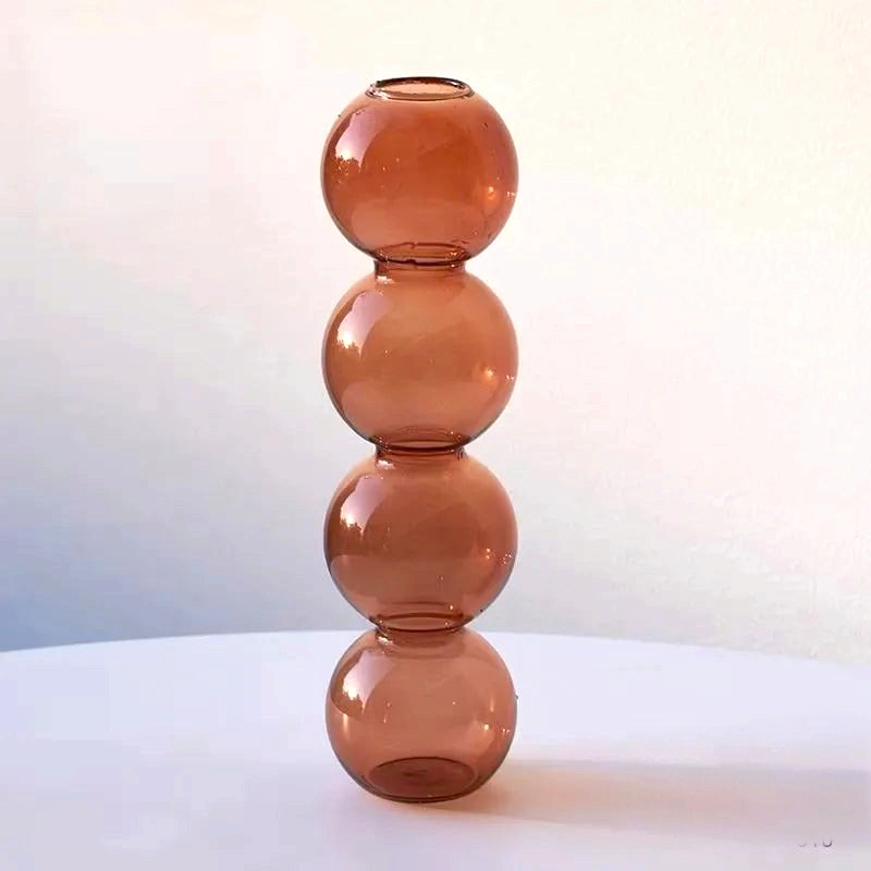 By Levin Nordic Bubble glass flower vase in a warm orange tone with a stacked sphere design for modern decor.