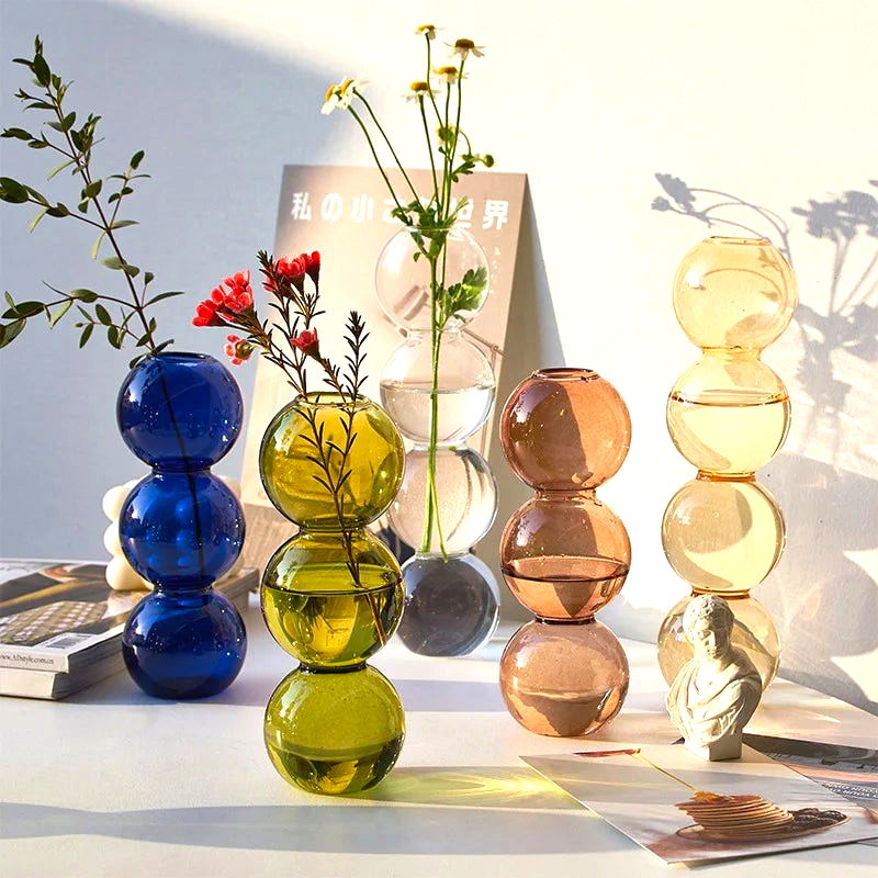 By Levin Nordic Bubble glass flower vases in various colors with stacked sphere designs on a white table