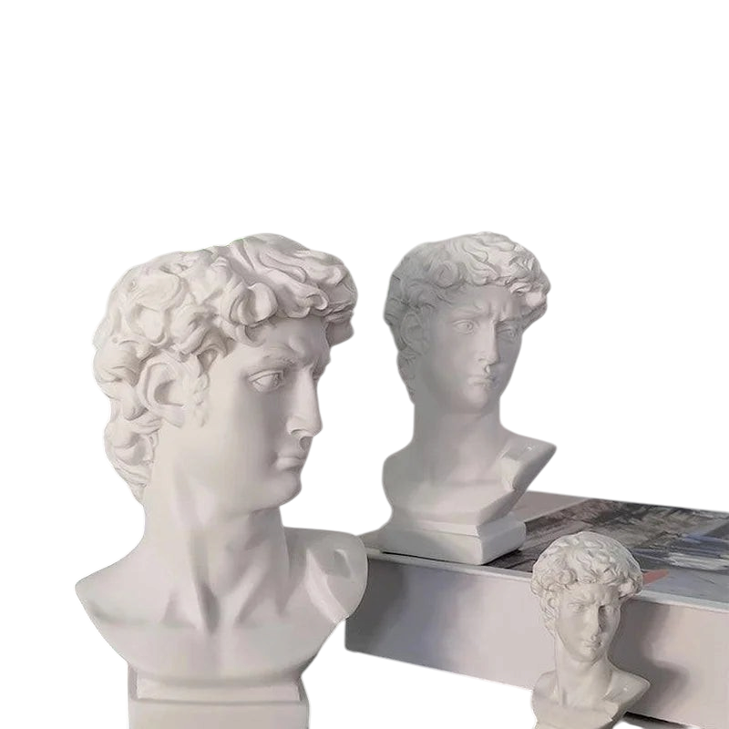 By Levin white resin David bust statues used as decorative vases and brush holders on a desk with green foliage
