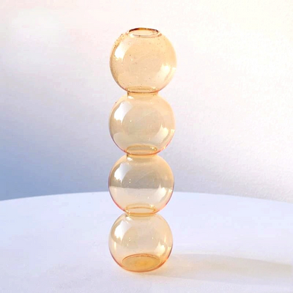 By Levin champagne-colored Nordic bubble glass flower vase with a stacked sphere design on a white surface.