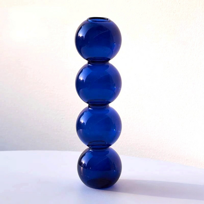 By Levin dark blue glass flower vase with a modern stacked bubble sphere design on a white surface