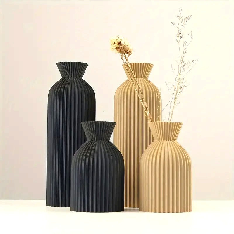 By Levin Nordic pleated plastic flower vases in matte black and khaki, featuring a modern minimalist design.