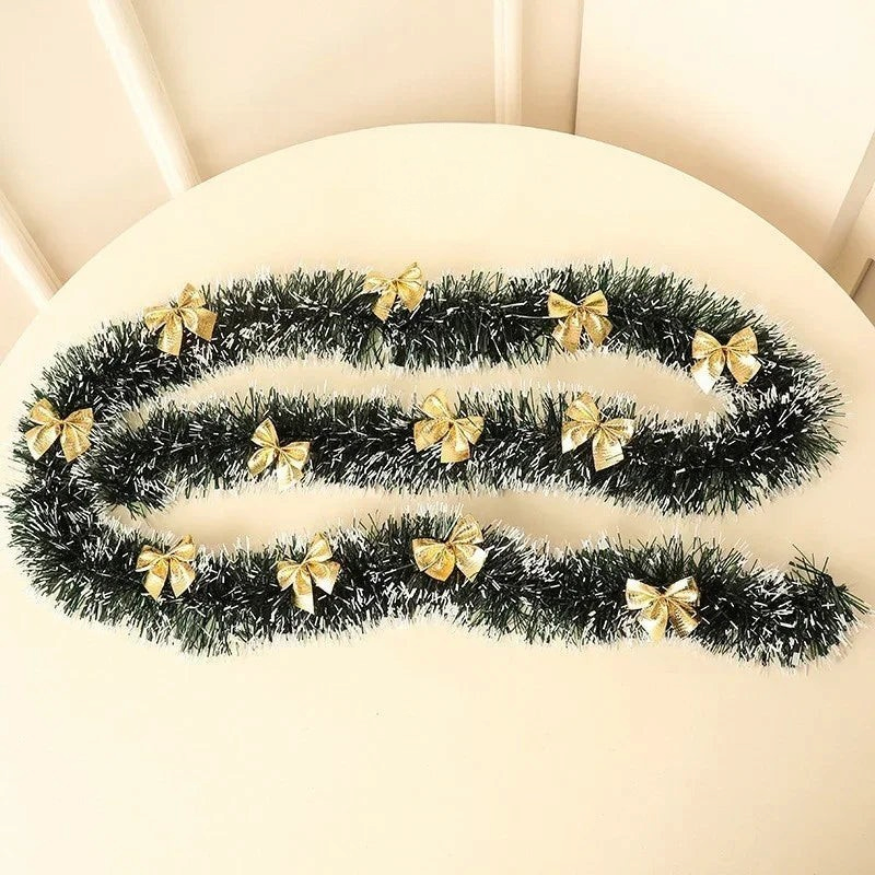 By Levin 2-meter green and white tinsel garland decorated with small gold bows for Christmas tree and home decor
