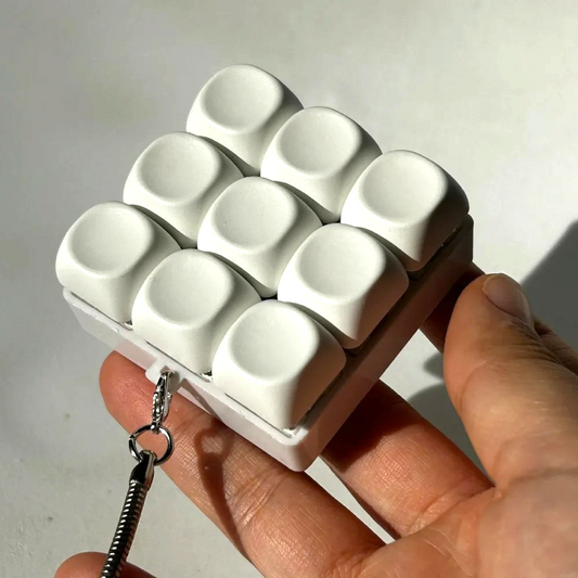 By Levin white 9-key mechanical keyboard fidget keychain for stress relief and focus held in hand